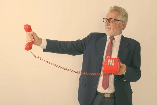 Studio Shot Senior Bearded Businessman Holding Looking Old Telephone While — Stock Photo, Image