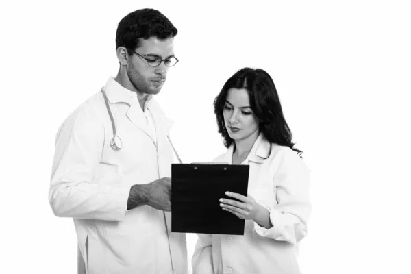 Studio Shot Young Man Woman Doctor Reading Clipboard Together — Stock Photo, Image
