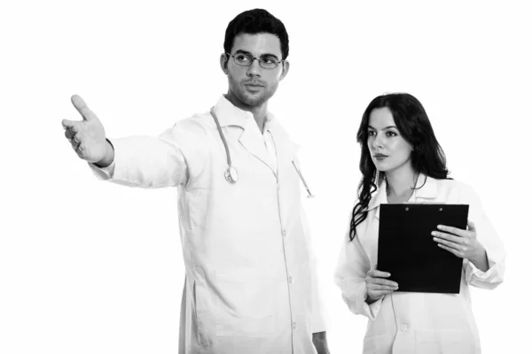Studio Shot Young Man Doctor Showing Something Woman Doctor Holding — Stock Photo, Image