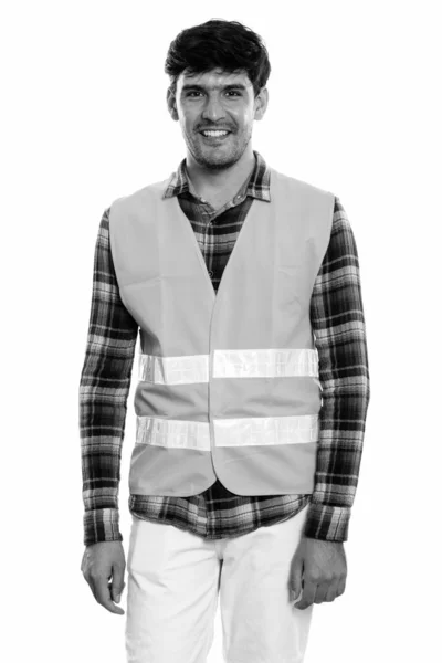 Studio shot of young happy Persian man construction worker smiling while standing — Stock Photo, Image