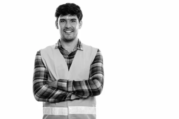 Studio shot of young happy Persian man construction worker smiling with arms crossed — Stock Photo, Image