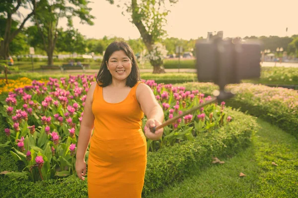 Beautiful overweight Asian woman relaxing at the park in the city of Bangkok, Thailand — Stock Photo, Image