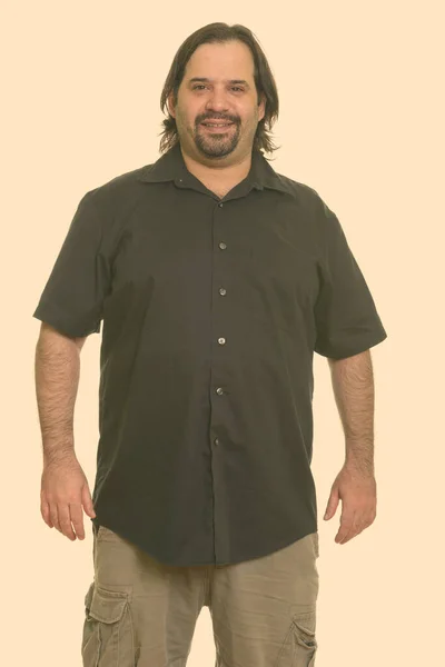 Portrait of bearded overweight Caucasian man against plain studio background — Stock Photo, Image