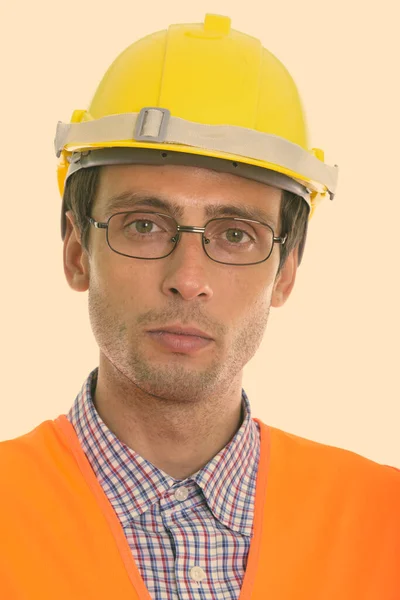 Gesicht eines jungen gutaussehenden Mannes Bauarbeiter mit Brille — Stockfoto