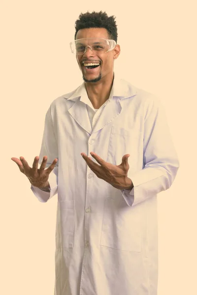 Studio shot of young happy African man doctor smiling while looking excited — Stock Photo, Image