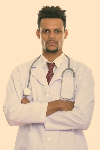 Studio shot of young African man doctor with arms crossed — Stock Photo, Image
