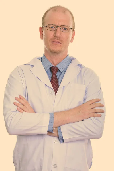 Studio shot of man doctor with arms crossed — Stock Photo, Image