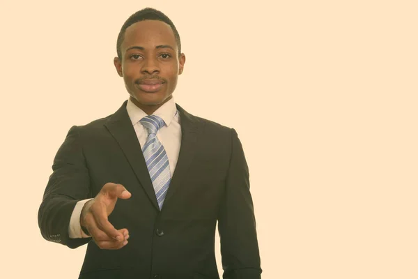 Young handsome African businessman giving handshake — Stock Photo, Image