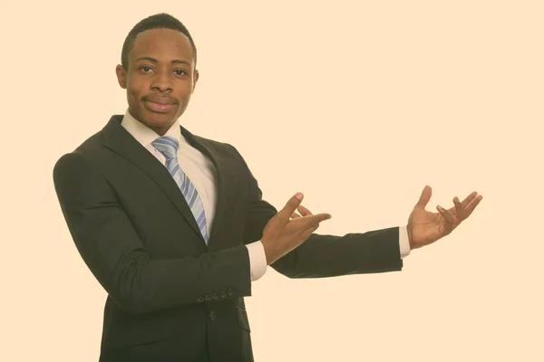 Young handsome African businessman showing something — Stock Photo, Image