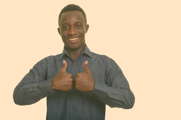 Young happy African man smiling giving thumbs up — Stock Photo, Image