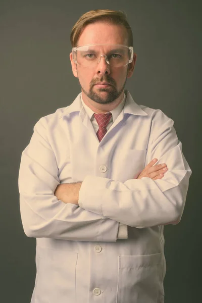 Blond bearded man doctor with goatee against gray background — Stock Photo, Image