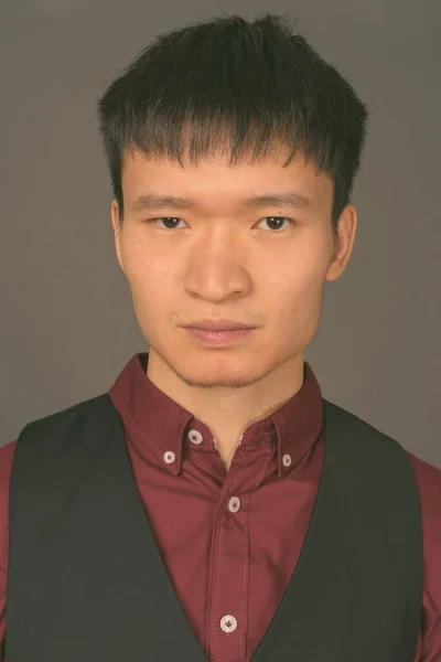 Молодий китайський бізнесмен проти сірого походження — стокове фото