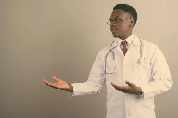 Young African man doctor against white background — Stock Photo, Image