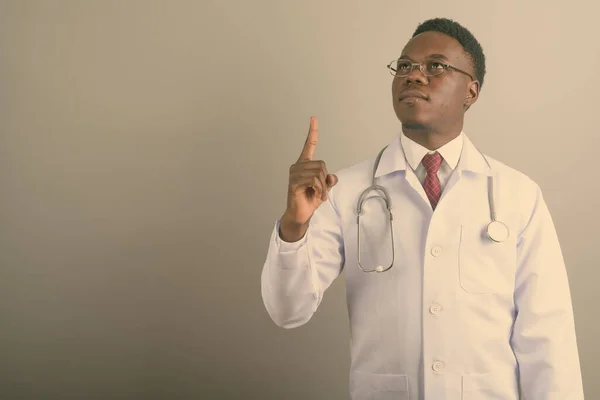 Young African man doctor against white background — Stock Photo, Image