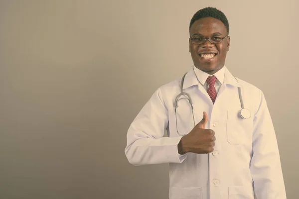 Young African man doctor against white background — Stock Photo, Image