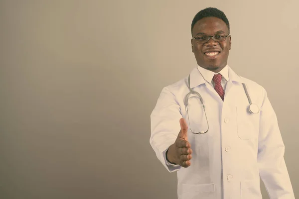 Young African man doctor against white background — Stock Photo, Image