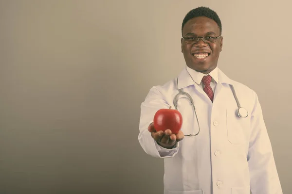 Young African man doctor against white background — Stock Photo, Image