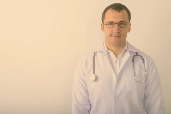 Estudio de tiro de joven musculoso médico hombre con gafas sobre fondo blanco —  Fotos de Stock