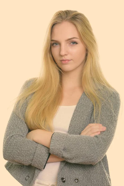 Studio shot of young beautiful businesswoman with arms crossed — Stock Photo, Image