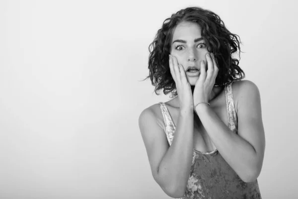 Black and white studio portrait of young Caucasian woman looking shocked — Stock Photo, Image