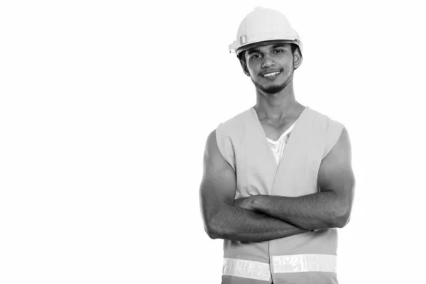 Studio shot of young happy Indian man construction worker smiling with arms crossed — Stock Photo, Image