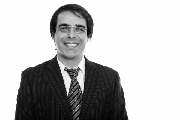 Studio shot of young happy Persian businessman smiling while wearing eyeglasses — Stock Photo, Image