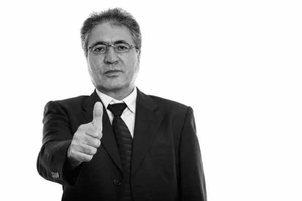 Studio shot of senior Persian businessman giving thumb up — Stock Photo, Image