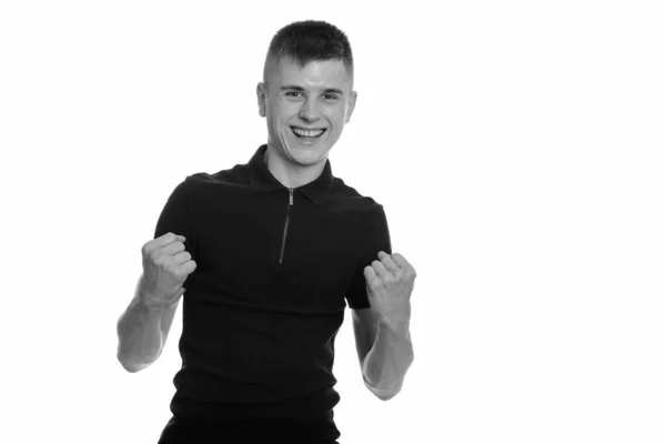 Young happy Caucasian man smiling and looking motivated with both arms raised — Stock Photo, Image