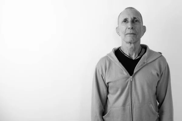 Studio shot of bald senior man against white background — Stock Photo, Image