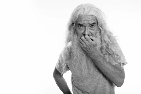 Studio záběr starší vousatý muž vypadající vystrašeně při zakrytí úst — Stock fotografie