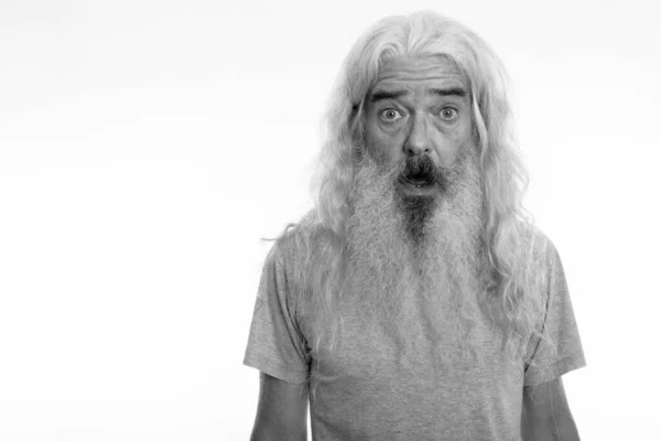 Studio shot of senior bearded man looking shocked — Stock Photo, Image