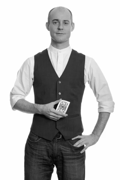 Bald Caucasian magician man holding Jack of Diamonds card with hand on hip — Stock Photo, Image