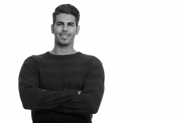 Young happy Persian man smiling with arms crossed — Stock Photo, Image