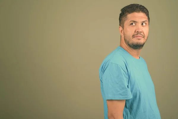 Hombre persa barbudo con camisa azul sobre fondo de color —  Fotos de Stock