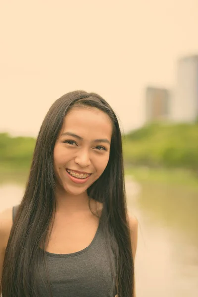 Jovem bela mulher asiática relaxante no parque — Fotografia de Stock