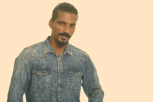 Portrait of happy young bearded Indian man with denim shirt — Stock Photo, Image