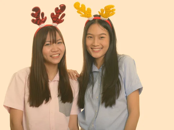 크리스마스를 위해 웃고 있는 행복 한 아시아 십 대 소녀 두 명 — 스톡 사진