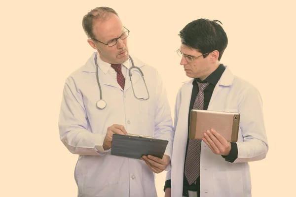 Mature Man Doctor Holding Clipboard Young Man Doctor Holding Digital — Stock Photo, Image