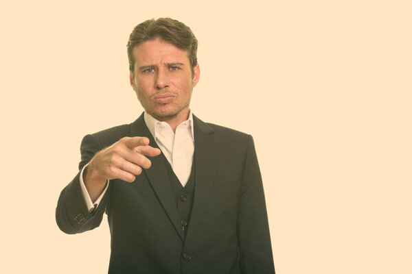 Portrait of Caucasian man with short hairstyle against plain studio background