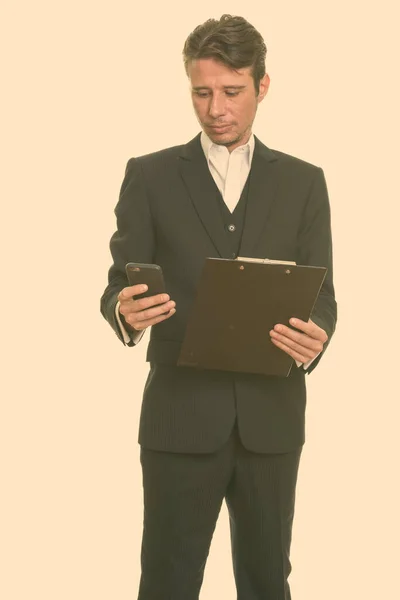 Portrait of Caucasian man with short hairstyle against plain studio background