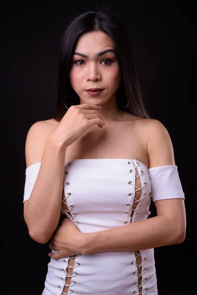 Young beautiful Asian transgender woman against black background — Stock Photo, Image