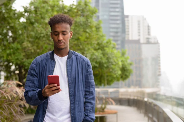 Portrait of handsome black African man at rooftop garden — Stock Photo, Image