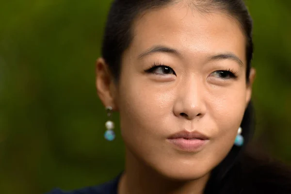 Portrait of beautiful rebel Korean woman face outdoors