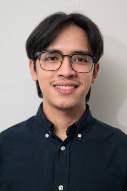 Beyaz arka planda 20 'li yaşlarda yakışıklı Asyalı genç Taylandlı bir adamın portresi