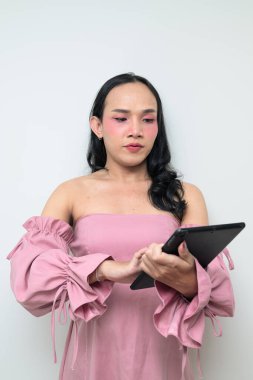 Makyajlı ve uzun saçlı Taylandlı genç bir transseksüelin stüdyo portresi. Cinsiyet ifadesi kavramı, LGBTQ gururu ve özgün güzellik ve çeşitliliği gösteren kapsayıcılık.