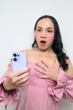 Makyajlı ve uzun saçlı Taylandlı genç bir transseksüelin stüdyo portresi. Cinsiyet ifadesi kavramı, LGBTQ gururu ve özgün güzellik ve çeşitliliği gösteren kapsayıcılık.