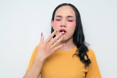 Makyajlı ve uzun saçlı Taylandlı genç bir transseksüelin stüdyo portresi. Cinsiyet ifadesi kavramı, LGBTQ gururu ve özgün güzellik ve çeşitliliği gösteren kapsayıcılık.