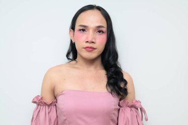 Makyajlı ve uzun saçlı Taylandlı genç bir transseksüelin stüdyo portresi. Cinsiyet ifadesi kavramı, LGBTQ gururu ve özgün güzellik ve çeşitliliği gösteren kapsayıcılık.