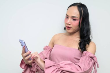 Makyajlı ve uzun saçlı Taylandlı genç bir transseksüelin stüdyo portresi. Cinsiyet ifadesi kavramı, LGBTQ gururu ve özgün güzellik ve çeşitliliği gösteren kapsayıcılık.