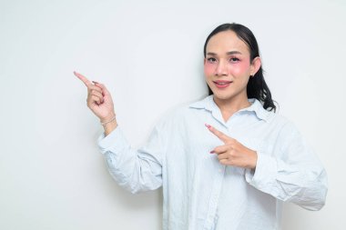 Makyajlı ve uzun saçlı Taylandlı genç bir transseksüelin stüdyo portresi. Cinsiyet ifadesi kavramı, LGBTQ gururu ve özgün güzellik ve çeşitliliği gösteren kapsayıcılık.